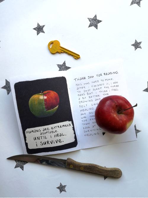 the last spread of my apple zine next to an apple, a knife, and a key